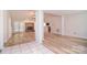 Open living room features hardwood flooring, brick fireplace, and a seamless transition to other spaces at 9117 Castle Garden Ln, Charlotte, NC 28215