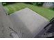 View of a gray paver patio alongside brick home and green lawn at 9117 Castle Garden Ln, Charlotte, NC 28215