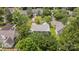 Aerial view of a home, highlighting its roof, lawn and mature trees in a well-maintained neighborhood at 9121 Four Acre Ct, Charlotte, NC 28210