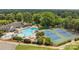 Aerial view of community amenities including a pool and tennis courts surrounded by lush landscaping at 9121 Four Acre Ct, Charlotte, NC 28210