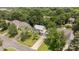 Aerial view of a home with green roof, long driveway and beautifully manicured lawn in a tree-filled community at 9121 Four Acre Ct, Charlotte, NC 28210