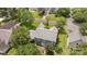 Aerial view of a home in a neighborhood, showcasing the property's roof, driveway and manicured lawn at 9121 Four Acre Ct, Charlotte, NC 28210