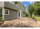 The home's neutral siding and brick patio are on full display, along with its white trim and well-maintained lawn at 9121 Four Acre Ct, Charlotte, NC 28210