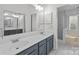 Large bathroom with double vanity and enclosed tub shower at 9121 Four Acre Ct, Charlotte, NC 28210