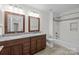 This spacious bathroom features dual sinks, granite counters, and a shower-tub combo at 9121 Four Acre Ct, Charlotte, NC 28210