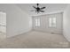Neutral bedroom with carpeting, ceiling fan, and natural light from two windows at 9121 Four Acre Ct, Charlotte, NC 28210