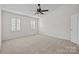 Spacious bedroom with plush carpeting, neutral walls, and natural light from two windows at 9121 Four Acre Ct, Charlotte, NC 28210