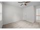 This bedroom offers neutral carpet, a ceiling fan, and a closet at 9121 Four Acre Ct, Charlotte, NC 28210