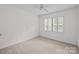 Bright bedroom with neutral carpet, ceiling fan and plantation shutters at 9121 Four Acre Ct, Charlotte, NC 28210