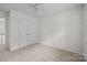 This bedroom offers neutral carpet, a ceiling fan, and a closet at 9121 Four Acre Ct, Charlotte, NC 28210