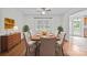 Dining room featuring hardwood floors, neutral walls, and a classic dining set with six chairs at 9121 Four Acre Ct, Charlotte, NC 28210