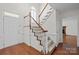 Open entryway featuring a staircase with wooden handrail and access to the living area at 9121 Four Acre Ct, Charlotte, NC 28210