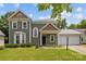 Inviting two-story home with a well-kept lawn, neatly trimmed bushes, and a two car garage at 9121 Four Acre Ct, Charlotte, NC 28210