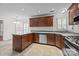 Bright eat-in kitchen with tiled floors, wood cabinets, and stainless steel dishwasher at 9121 Four Acre Ct, Charlotte, NC 28210
