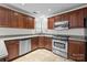 Well-lit kitchen featuring stainless steel appliances and beautiful wood cabinetry at 9121 Four Acre Ct, Charlotte, NC 28210