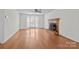 Bright living room features hardwood floors, a ceiling fan, and a cozy fireplace at 9121 Four Acre Ct, Charlotte, NC 28210