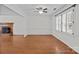 Spacious living room features hardwood floors, neutral walls, and a ceiling fan at 9121 Four Acre Ct, Charlotte, NC 28210