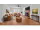 Cozy living room featuring hardwood floors, a fireplace, comfortable seating, and a bright bay window at 9121 Four Acre Ct, Charlotte, NC 28210