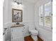 Charming powder room with hardwood floors, stylish sink and window with wooden shutters at 9121 Four Acre Ct, Charlotte, NC 28210