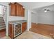 Elegant bar area with a wine cooler, granite countertops, and seamless access to the living room at 9121 Four Acre Ct, Charlotte, NC 28210