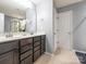 Bathroom featuring a dual sink vanity and walk-in shower with glass doors at 9123 Magnolia Lily Ave, Charlotte, NC 28227