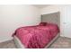 Bedroom with a tufted headboard and a red velvet comforter at 9123 Magnolia Lily Ave, Charlotte, NC 28227