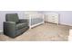 Bedroom featuring a gray glider, white crib, dresser, and neutral carpeting at 9123 Magnolia Lily Ave, Charlotte, NC 28227