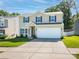 Charming two-story home with a well-maintained lawn, neutral siding, and a two-car garage at 9123 Magnolia Lily Ave, Charlotte, NC 28227