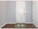 Hallway with white door, laminate flooring, and decorative rug at 9123 Magnolia Lily Ave, Charlotte, NC 28227