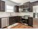 Well-equipped kitchen with stainless steel appliances, modern cabinets, and tile backsplash at 9123 Magnolia Lily Ave, Charlotte, NC 28227