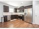 Well-equipped kitchen with stainless steel appliances, granite countertops, and dark wood cabinetry and flooring at 9123 Magnolia Lily Ave, Charlotte, NC 28227