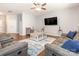 Spacious living room featuring hardwood floors, dual couches, a TV and contemporary décor at 9123 Magnolia Lily Ave, Charlotte, NC 28227