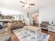 Open-concept living area with hardwood flooring, a comfortable seating arrangement, and great natural light at 9123 Magnolia Lily Ave, Charlotte, NC 28227