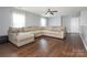 Bright living room featuring a sectional sofa, dark wood floors, and a ceiling fan at 9123 Magnolia Lily Ave, Charlotte, NC 28227