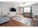 Comfortable living room with hardwood floors, a ceiling fan, and a plush sofa and chair at 9123 Magnolia Lily Ave, Charlotte, NC 28227