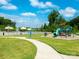 Community playground and pool with a slide, lush greenery, and open skies for Gathering fun at 9123 Magnolia Lily Ave, Charlotte, NC 28227