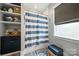 Bathroom features blue striped shower curtain, gray accents and storage shelves at 956 Herrons Ferry Rd, Rock Hill, SC 29730