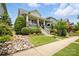 Well-maintained home with a charming front porch and lush landscaping with a rock garden at 956 Herrons Ferry Rd, Rock Hill, SC 29730
