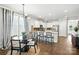 Eat-in kitchen featuring stainless appliances, granite counters, breakfast bar, and dining table with hardwood floors at 956 Herrons Ferry Rd, Rock Hill, SC 29730