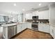 Modern kitchen featuring stainless steel appliances, granite countertops, and a view of the living area at 956 Herrons Ferry Rd, Rock Hill, SC 29730