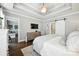 Spacious main bedroom featuring a tray ceiling, hardwood floors and ensuite bathroom access through sliding barn door at 956 Herrons Ferry Rd, Rock Hill, SC 29730