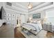 Comfortable main bedroom featuring a tray ceiling, ensuite bathroom access and stylish decor with hardwood floors at 956 Herrons Ferry Rd, Rock Hill, SC 29730