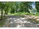 Scenic walking path with lush trees and partial water views in a tranquil, natural setting at 956 Herrons Ferry Rd, Rock Hill, SC 29730