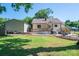 This home features a spacious backyard with a deck, a patio, and a detached garage at 1005 Noles Dr, Mount Holly, NC 28120