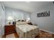 Comfortable bedroom with hardwood floors, a window, and classic furnishings for a restful retreat at 1005 Noles Dr, Mount Holly, NC 28120