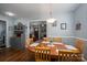Inviting dining room with hardwood floors and an oval wooden table adjacent to the living room and kitchen at 1005 Noles Dr, Mount Holly, NC 28120