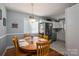 Bright dining area open to the kitchen, featuring a wooden table, hardwood floors, and ample natural light at 1005 Noles Dr, Mount Holly, NC 28120