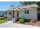 Charming home featuring neutral siding, landscaped garden beds, and a welcoming front entrance at 1005 Noles Dr, Mount Holly, NC 28120