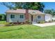 Attractive home exterior with a lush green lawn and a detached garage at 1005 Noles Dr, Mount Holly, NC 28120