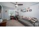 Cozy living room featuring a ceiling fan, gray sofa, and carpeted floors for a relaxing atmosphere at 1005 Noles Dr, Mount Holly, NC 28120
